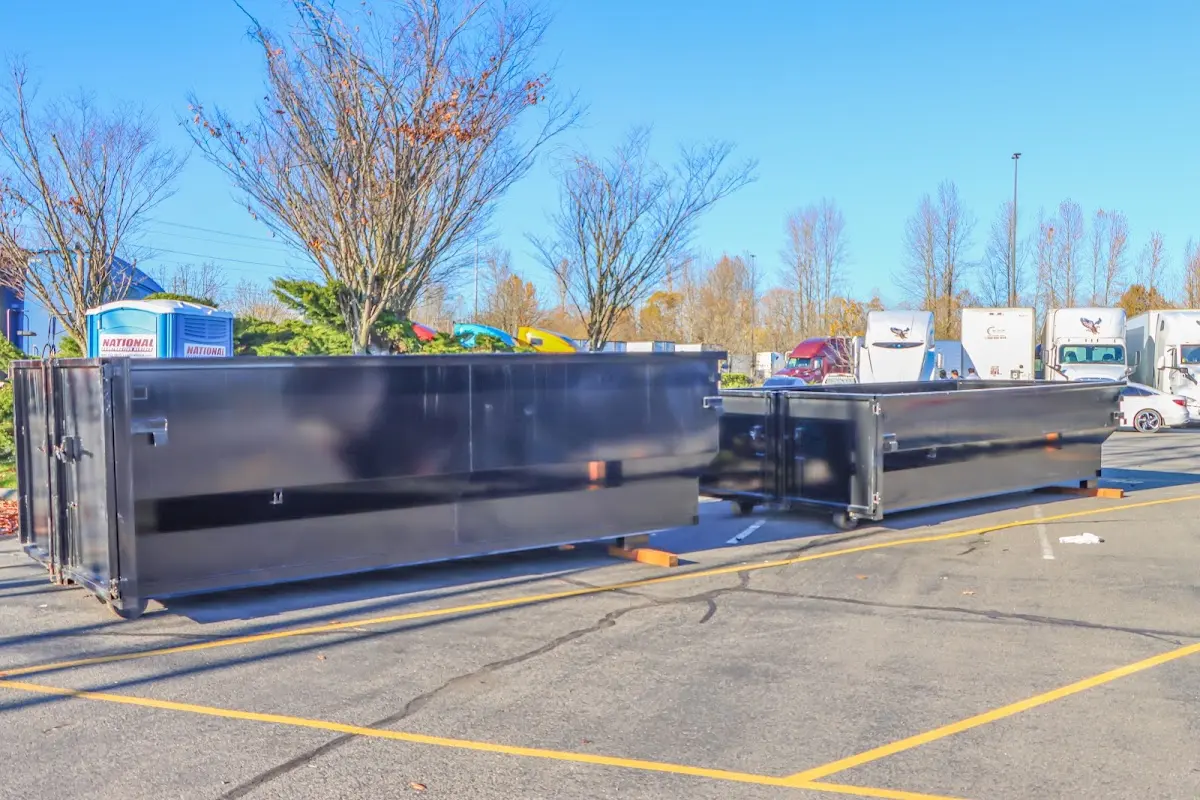 Professional dumpster rental service with roll-off container on residential driveway in Brentwood